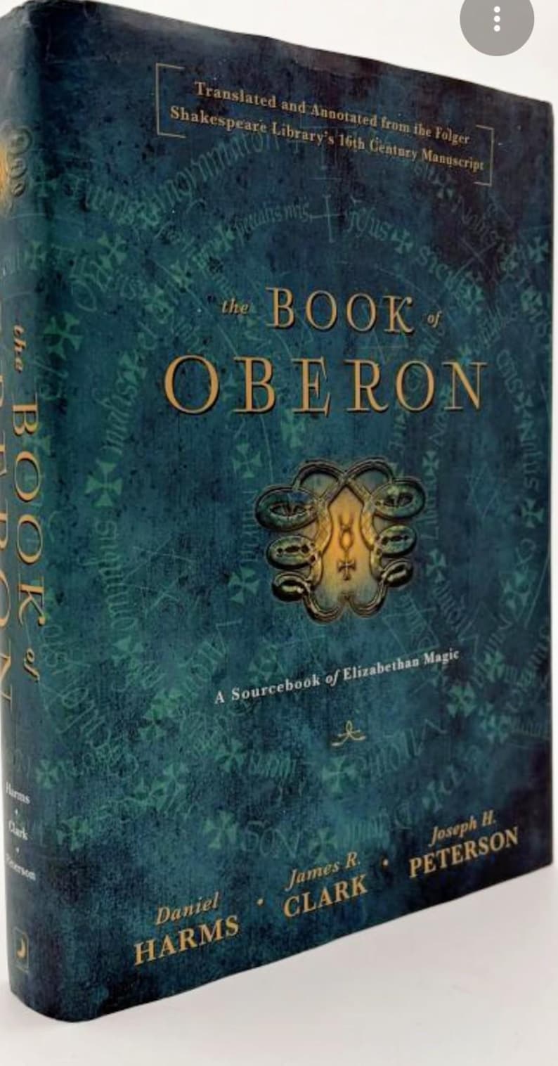 May include: A hardback book titled "the BOOK of OBERON" with a teal cover and gold lettering. The cover features an ornate emblem and text that reads "A Sourcebook of Elizabethan Magic". Authors include Daniel Harms, James R. Clark, and Joseph H. Peterson.