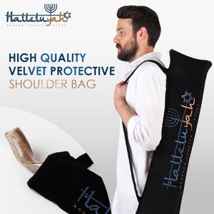 Op de afbeelding: Een zwarte fluwelen schoudertas met een band. De tas heeft de tekst "Halleluyah" geborduurd in blauwe en gouden draad. De tas is ontworpen om een sjofar in te bewaren.