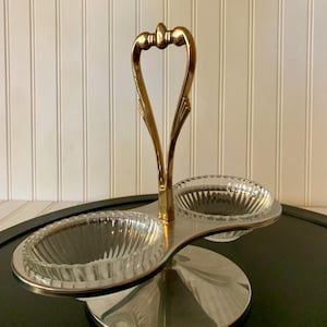 May include: A white ceramic mug with a black handle and the text "But First, Coffee" in a black, bold font. The mug is sitting on a white surface.