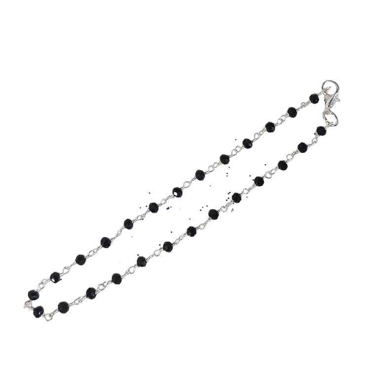 May include: A silver chain necklace with black beads. The necklace has a lobster clasp closure.