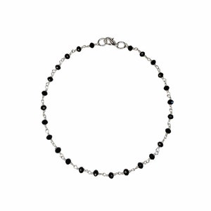 May include: A silver chain bracelet with black beads.