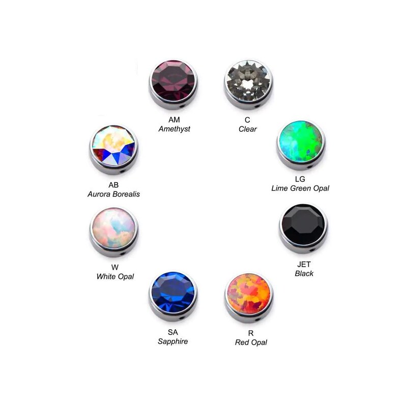 Puede incluir: Surtido de 10 gemas redondas de diferentes colores y texturas para la elaboraci&oacute;n de joyas. Las gemas se muestran sobre un fondo blanco. Las gemas incluyen amatista, transparente, aurora boreal, &oacute;palo blanco, zafiro, &oacute;palo rojo, &oacute;palo verde lima, negro y azabache.