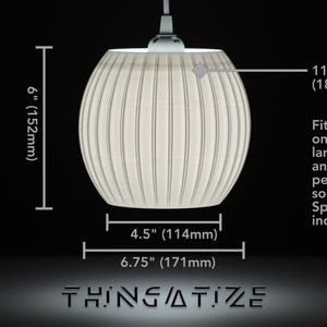 May include: A white, ribbed pendant light fixture with dimensions displayed. The light is 6 inches (152mm) tall, 4.5 inches (114mm) wide, and 6.75 inches (171mm) in diameter. It has an 11/16 inch (18mm) offset and fits lamp bases and 1 5/8 inch pendant sockets.