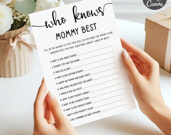 May include: A white baby shower game card with the text "who knows MOMMY BEST" in black script. The card includes fill-in-the-blank questions about the mom-to-be. The card is held by a person.
