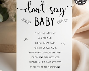 May include: A white card with the text "don't say BABY" in black script. The card includes instructions for a baby shower game, with decorative floral elements and hearts. The Canva logo is in the upper right corner.