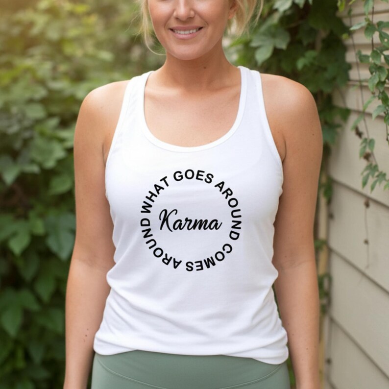 May include: White tank top with the text "Karma" in a circular design. The text "WHAT GOES AROUND COMES AROUND" surrounds the word "Karma". The tank top is sleeveless and has a scoop neck.