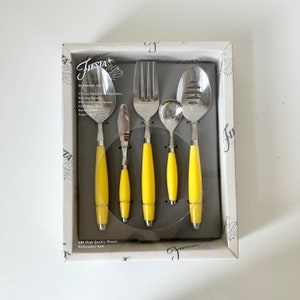 May include: A boxed set of Fiesta brand serving utensils. The set includes a serving spoon, slotted serving spoon, cold meat fork, butter knife, and sugar shell. Each utensil has a bright yellow handle and stainless steel head.