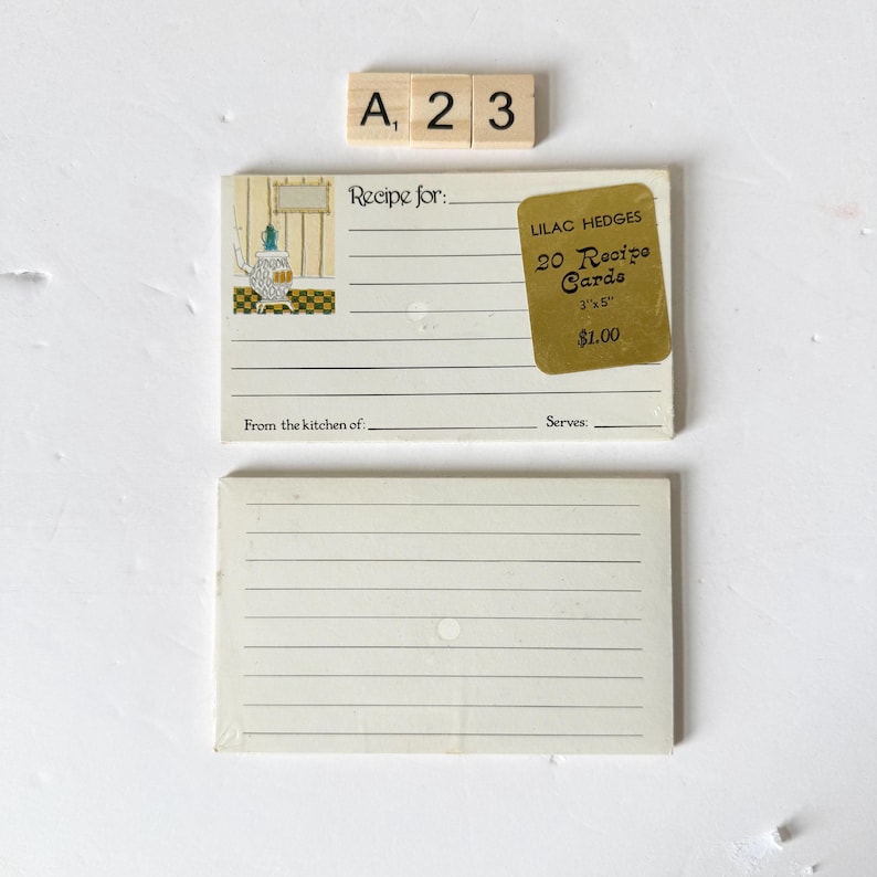 May include: Two recipe cards with lined pages, one with a decorative illustration of a teapot and the text "Recipe for:" and "From the kitchen of:". A sticker reads "LILAC HEDGES 20 Recipe Cards 3"x5"", and wooden letter tiles spell "A, 2, 3".