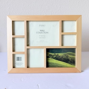 May include: A light-colored solid wood collage picture frame with eight openings. The center insert features the text Furio Home Wall Collection 8 Openings Solid Wood Frame Size 12 in x 15 in. One opening displays a landscape photo of green hills.