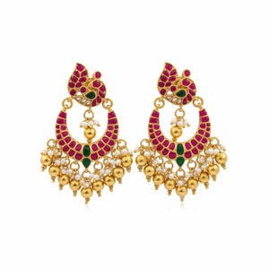 May include: A pair of gold-toned earrings with a crescent-shaped design. The earrings feature red and green accents, along with dangling gold beads and small white pearls. The top portion has a decorative, stylized design.