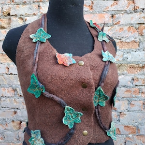 May include: A brown felt waistcoat with green and orange felt leaves and vines appliqued on the front.
