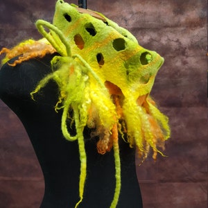 May include: A lime green and yellow felted wool scarf with a unique openwork design and long, flowing fringe.