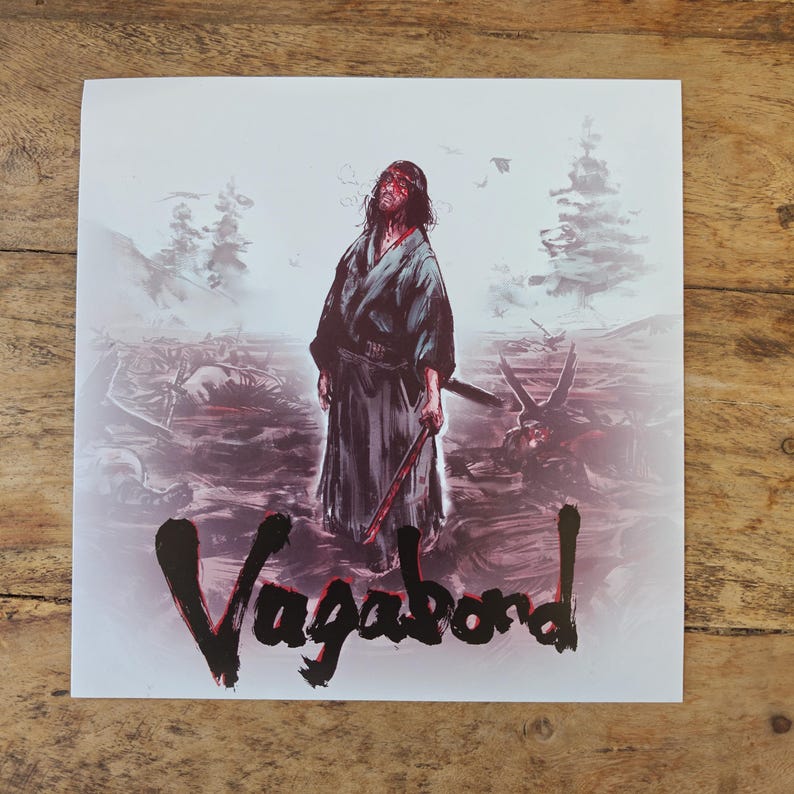 May include: Square print featuring a warrior in a dark robe, holding a bloodied sword, with the word "Vagabond" in bold, black lettering. The background depicts a battle scene with a red and gray color palette.