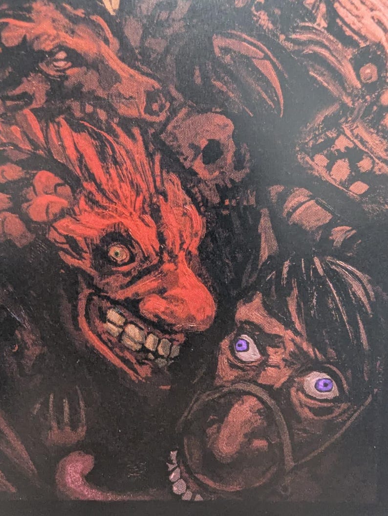 May include: A dark, detailed illustration featuring a red, demonic face with a wide grin and sharp teeth. Other faces and skulls are partially visible in the background, with purple eyes and a dark color palette.