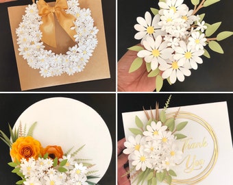 May include: Four different paper flower arrangements. The first is a wreath of white paper daisies on a brown paper bag. The second is a bouquet of white paper daisies with green paper leaves. The third is a bouquet of white paper daisies with green paper leaves and a yellow paper rose on a white background. The fourth is a bouquet of white paper daisies with green paper leaves on a white card with gold lettering that says "Thank You".