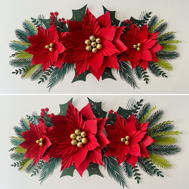 May include: A festive Christmas garland with three red poinsettia paper flowers, green leaves, and gold glitter balls.
