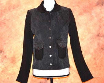 May include: A dark gray suede jacket with black knit sleeves and collar. The jacket features a button-up front, two front pockets, and a tailored fit. The jacket is displayed on a mannequin.