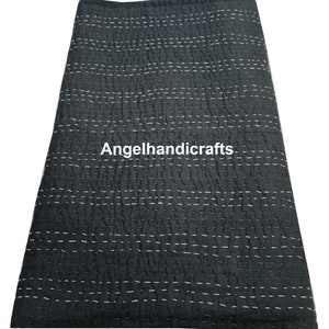 May include: A black kantha quilt with white stitching. The quilt is made of cotton and is hand-stitched. The quilt is folded in half and is lying flat on a white surface. The text "Angelhandicrafts" is visible in the center of the quilt.