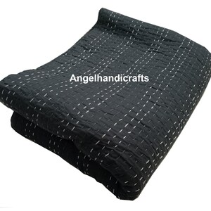 May include: Black kantha quilt with white stitching. The quilt is folded in half and the text "Angelhandicrafts" is visible in the center.