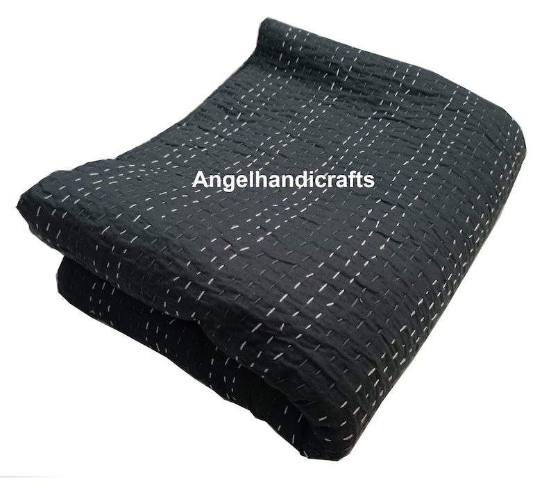 May include: Black kantha quilt with white stitching. The quilt is folded in half and the text "Angelhandicrafts" is visible in the center.