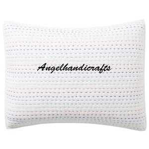 May include: White pillow with a colorful striped pattern and the text "Angelhandicrafts" embroidered in black.