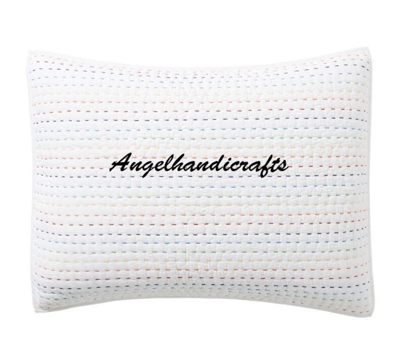 May include: White pillow with a colorful striped pattern and the text "Angelhandicrafts" embroidered in black.