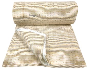 May include: A beige and brown striped cotton quilt with a white border. The quilt is rolled up and the label "Angel Handicraft" is visible.