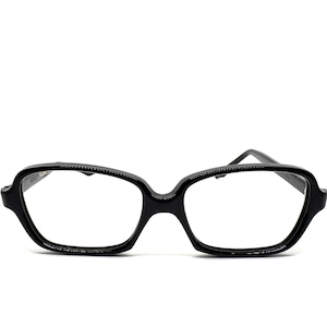 May include: Glossy black eyeglasses featuring a thick, rounded rectangular frame with a smooth finish. The glasses have a prominent bridge and sturdy temples extending from the sides, providing a clear view of the front-facing lens openings.