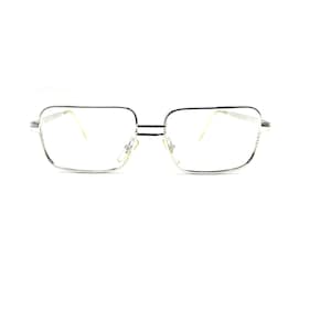 May include: A pair of silver-toned metal spectacles featuring a rectangular frame shape with a double bridge design. The glasses have clear lenses, thin metallic temples, and adjustable nose pads, presenting a clean and structured appearance.