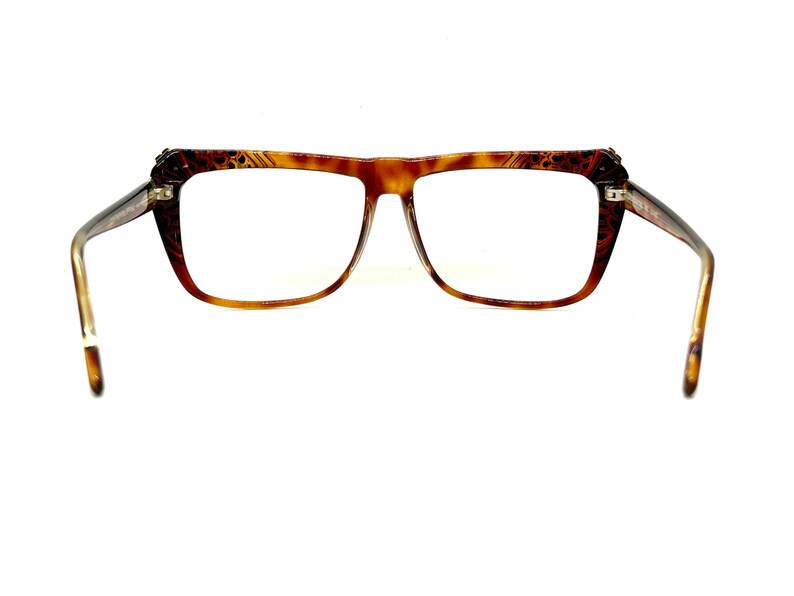 May include: A pair of brown tortoise shell eyeglasses with a square frame.
