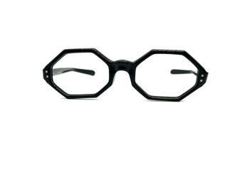 May include: Black octagon-shaped eyeglasses with a clear lens.