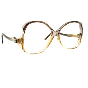 May include: A pair of brown and clear plastic spectacles with a large, rounded frame.