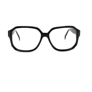 May include: Black, oversized eyeglasses with a geometric frame. The glasses have a thick, angular frame and thin temples. The lenses are clear. The glasses are set against a white background.
