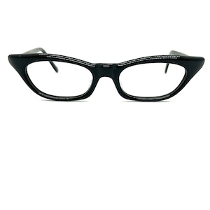 May include: Black cat-eye glasses with clear lenses.