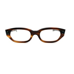 May include: Brown tortoiseshell eyeglasses with a rectangular frame and clear lenses. The glasses have small decorative studs on the outer corners of the frame.