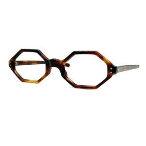 May include: A pair of tortoiseshell eyeglasses with octagonal frames.