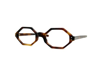 May include: A pair of tortoiseshell eyeglasses with octagonal frames.