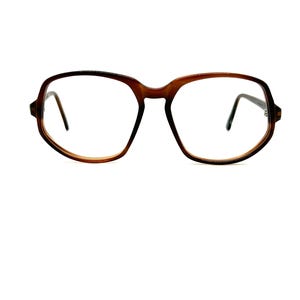 May include: Brown tortoiseshell eyeglasses with a geometric frame shape.