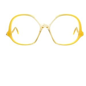 May include: Yellow plastic framed eyeglasses with a rounded, almost oval shape.
