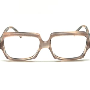 May include: A pair of brown plastic eyeglasses with square frames.