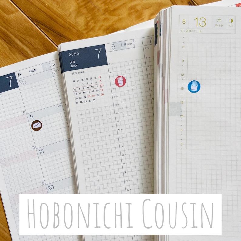 May include: A Hobonichi Cousin planner with a gridded layout. The planner is open to July 2020, with a sticker of a coffee cup on the 7th and a sticker of a mail envelope on the 6th. The planner is open to July 2020, with a sticker of a coffee cup on the 7th and a sticker of a mail envelope on the 6th.