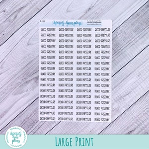 May include: A white rectangular sticker sheet featuring multiple rows of black text that reads BLOOD PRESSURE. The top of the sheet includes the text F-122, mandy lynn plans, and social media information. The stickers are arranged in a grid format.
