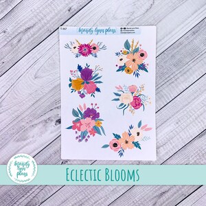 May include: A sticker sheet with various floral designs in shades of pink, purple, yellow, and peach. The sheet includes the text "Eclectic Blooms" and the brand name "Mandy Lynn Plans". The stickers are set against a white backdrop.