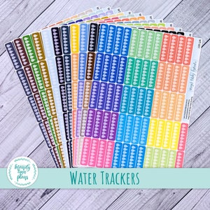 May include: A set of 16 colourful water tracker stickers with white raindrop icons. The stickers are arranged in a fan shape and have the text "WATER TRACKERS" at the bottom. The stickers are from the shop "Mandy Lynn Plans".