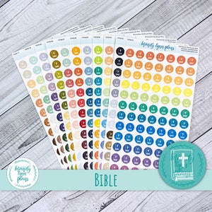 May include: A set of 12 sheets of colorful Bible stickers with a white outline of a closed book with a cross on the cover. Each sheet has 49 stickers in a rainbow of colors, including red, orange, yellow, green, blue, purple, and brown. The stickers are arranged in rows and columns on each sheet. The sheets are labeled with numbers and the words "Mandy Lynn Plans". The word "BIBLE" is printed in white letters on a light blue background at the bottom of the image.