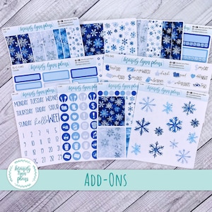 May include: A collection of planner stickers with a winter theme. The stickers feature snowflakes, blue and white color schemes, and various functional designs. The set includes labels, decorative elements, and calendar stickers. The text "Mandy Lynn Plans" is visible on the stickers.