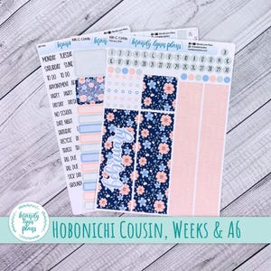 May include: Planner stickers with a floral design in navy blue and peach. The stickers include labels for appointments, to-do lists, and dates. The text "February" is featured on one sticker sheet. The stickers are for Hobonichi Cousin, Weeks & A6 planners.