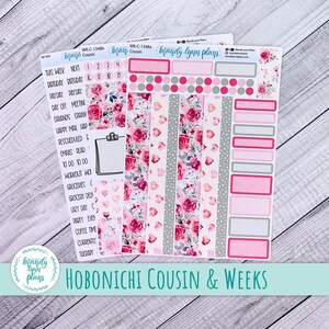 May include: Planner stickers with floral and heart patterns in pink, white, and gray. The stickers include labels for scheduling and planning, with the text "Hobonichi Cousin & Weeks".
