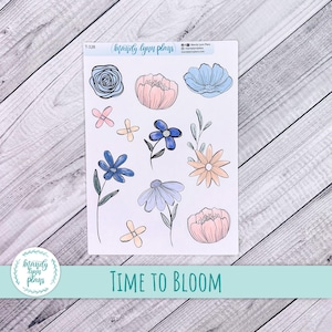 May include: A sheet of floral stickers with blue, pink, and peach flower designs. The stickers include roses, daisies, and other stylized blooms. The text "TIME TO BLOOM" is printed at the bottom of the sheet.