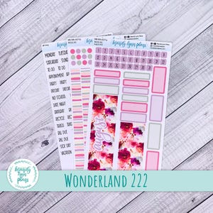 May include: Planner stickers with a floral design and the word "August". The stickers include labels for days of the week, appointments, and other events. The text "Wonderland 222" is also visible.